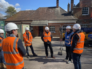 Pictured; Mark Miller (blue jacket) briefs Steve Brine MP at the works site joined by representatives from SWR and the contractors.